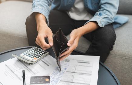 Man looking in wallet 