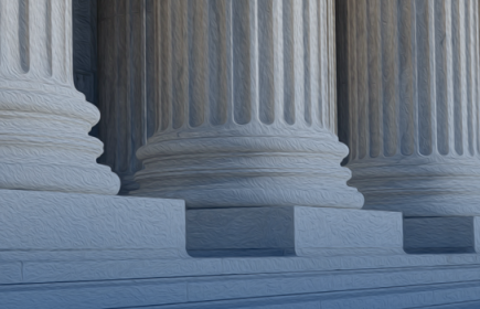 Photo of three massive architectural columns at the top of steps