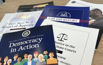 Photo of a variety of publications including an Annual Report, Democracy in Action booklet for jurors, a Law Day Report and a publication titled "There Shall Be A Court of Appeals."
